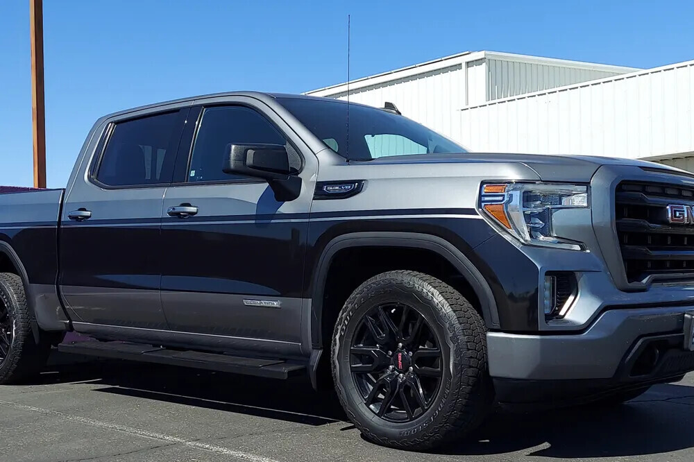 Black and silver pickup truck with a two-tone vinyl wrap
