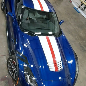 Blue Corvette with red and white racing stripes