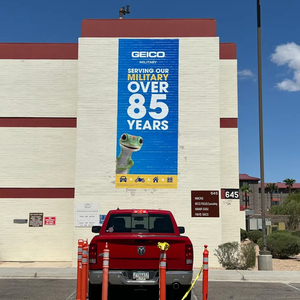 GEICO military banner on a building wall
