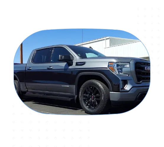 Black and silver GMC Sierra pickup truck with a two-tone vinyl wrap